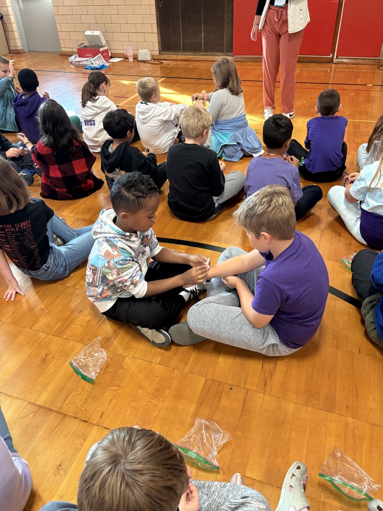 Students putting bracelets on each other 