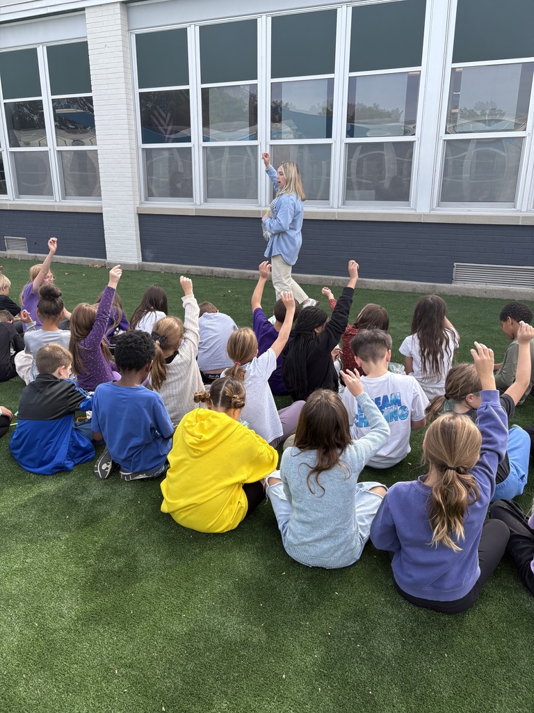 students sitting and raising hands 