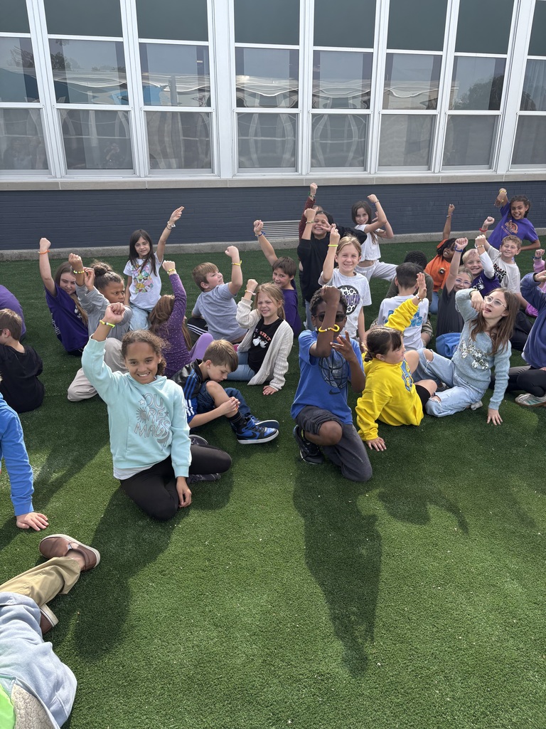 Kiddos showing their pumpkin life cycle bracelet 