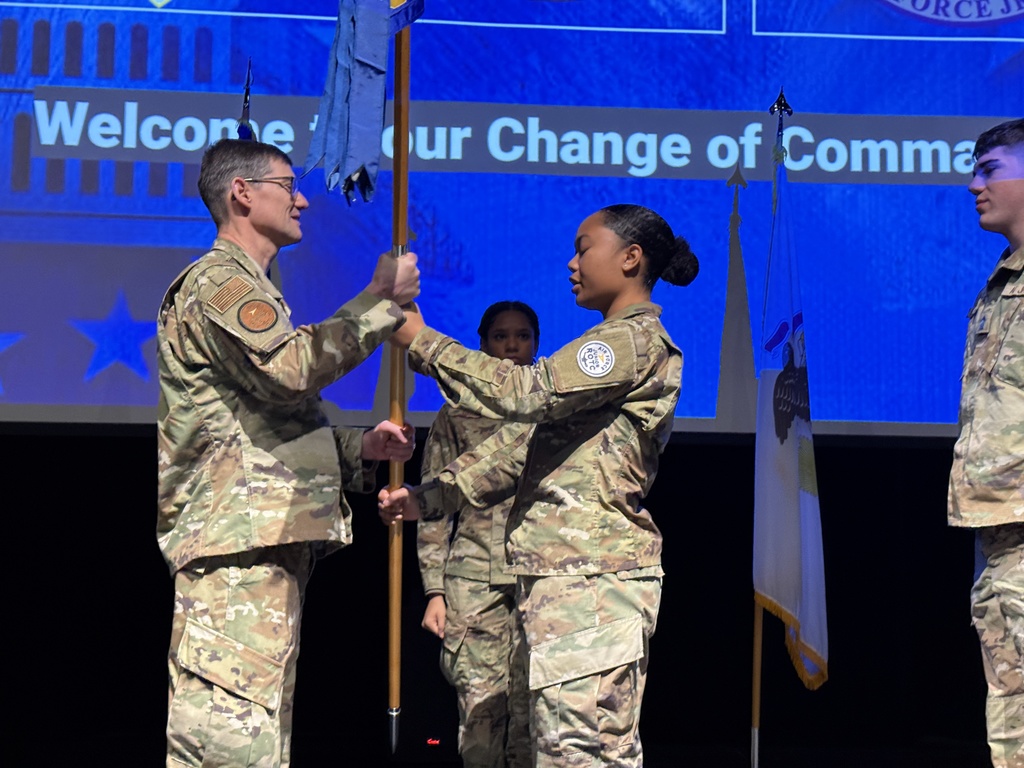 Cadet Tavake-Dural passing the guidon during the ceremony