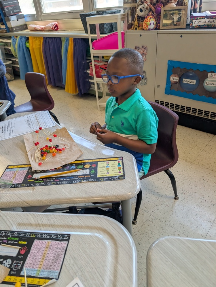 boy using jellybeans to make a creation