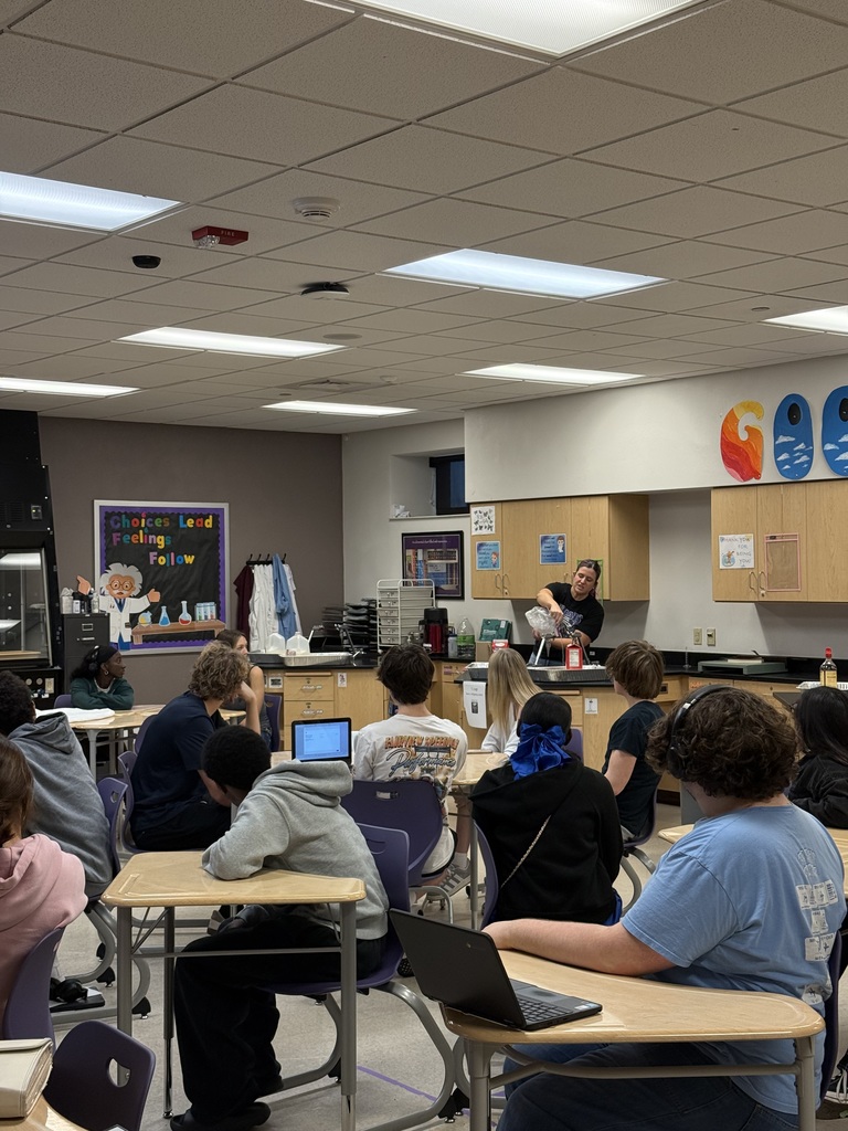 Teacher demonstrates shaking ice cream.