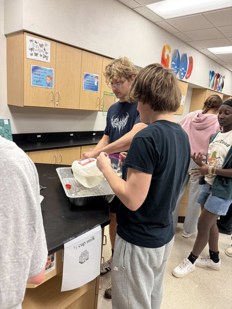Students adding milk