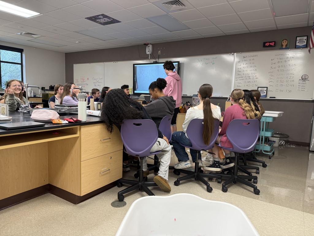 Students listening to a fellow student read their storybook.