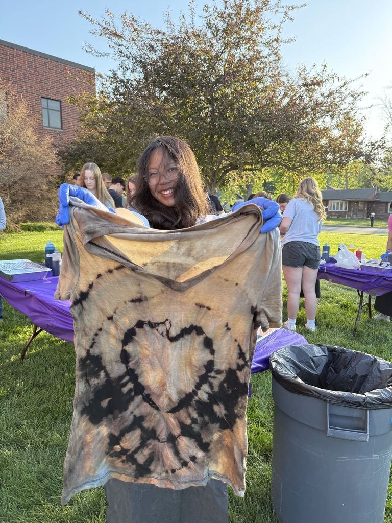 A student displays a bleached shirt with a heart design