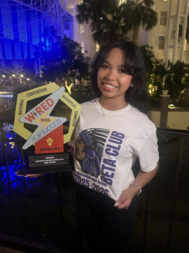 Olivia Lubang holding her trophy wearing her MHS Beta Club shirt!