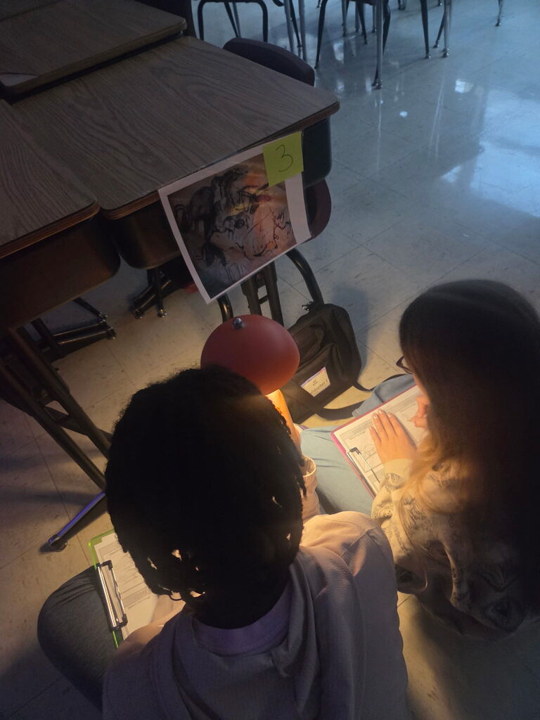 Students examine cave art and theorize why it was created