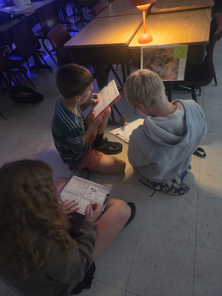Students examine cave art and theorize why it was created