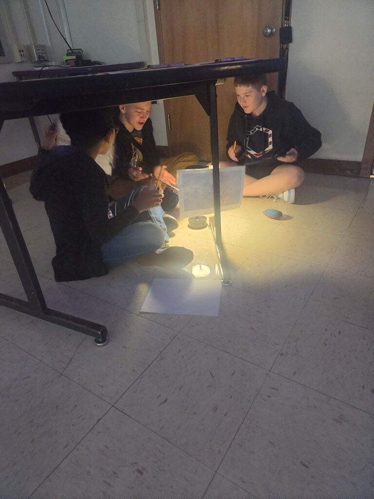 Students examine cave art and theorize why it was created
