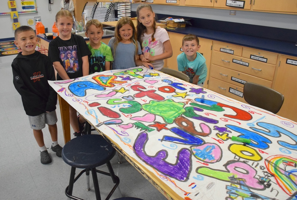 McKenna students displaying their Pop rt Murals
