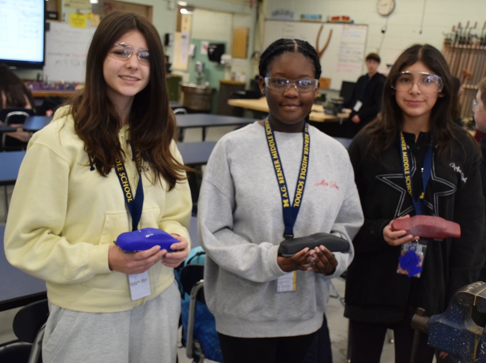 Berner students displaying the miniature race cars they built