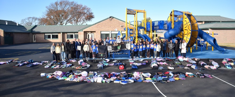 Spelling out “Massapequa,” more than 400 backpacks covered the blacktop at Birch Lane 