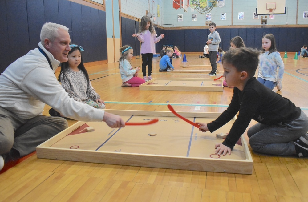 East Lake Principal, Mr. McKillop joins students in a game of knock hockey on Global School Play Day