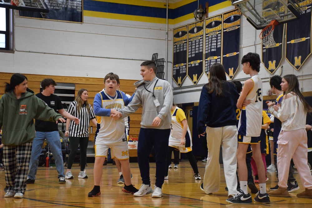 Challenger basketball player supported by his MHS Best Buddies Club friend