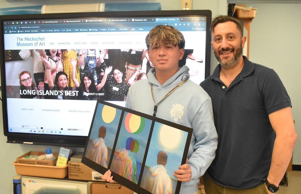 Luis Moreno and Mr. Paul Leone, AP Art Teacher, holding Luis' artwork featured in the Long Island’s Best Young Artists exhibition at the Heckscher Museum of Art