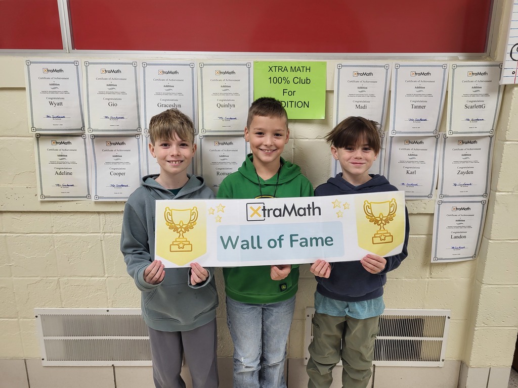 Mathews Elementary 3rd-grade Xtra Math Club winners smiling and holding their certificates.