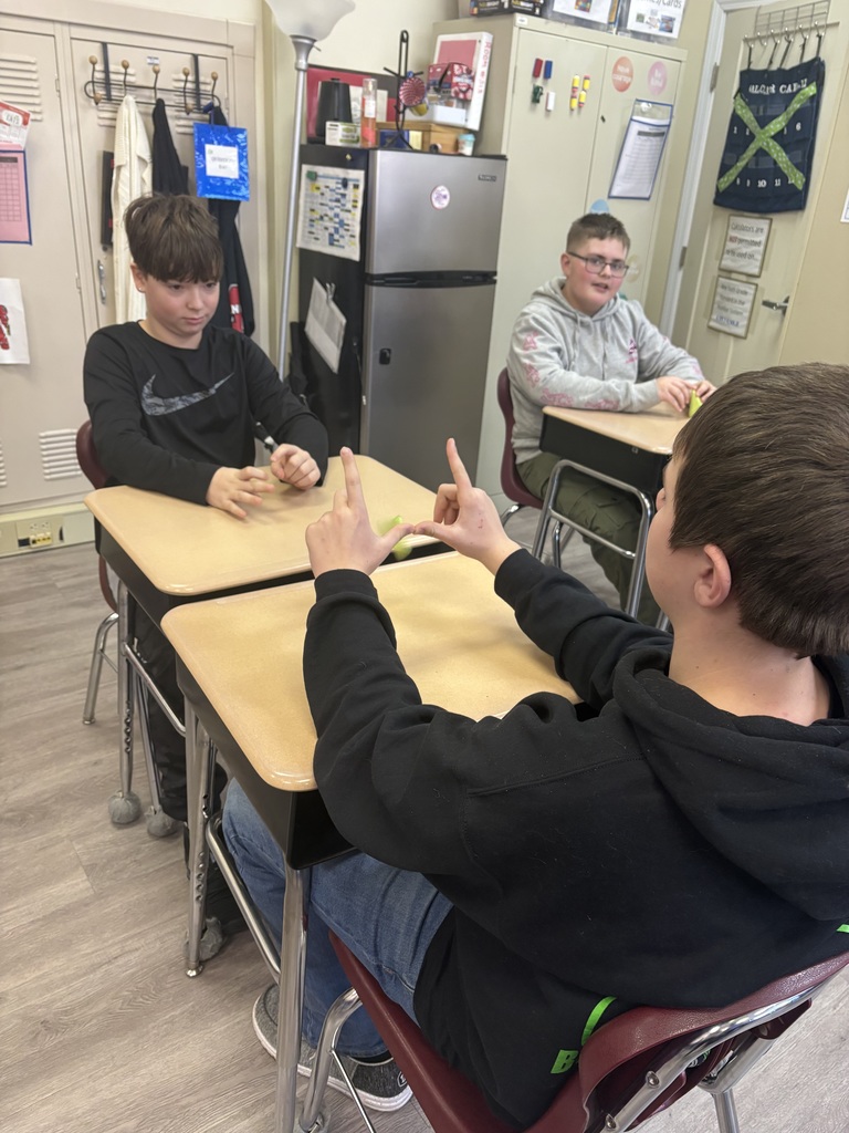 Students creating football histograms