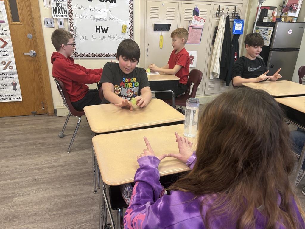 Students creating football histograms