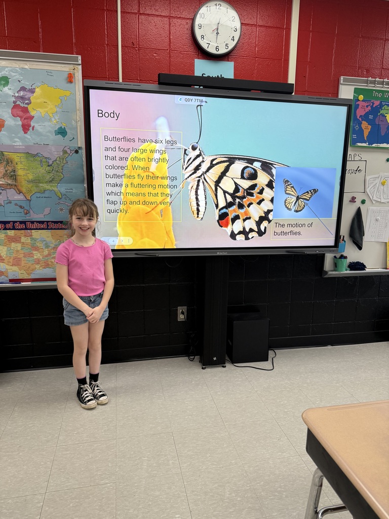 Elementary students presenting a slideshow about insect life cycles