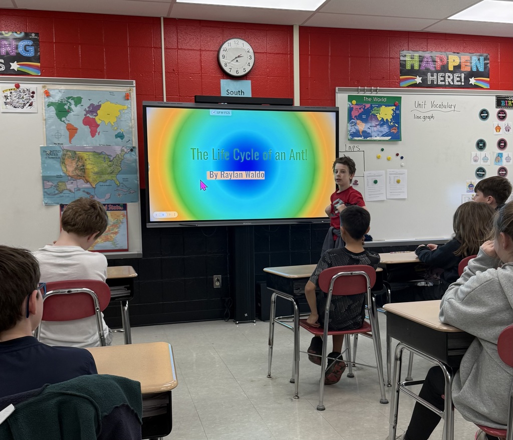 Elementary students presenting a slideshow about insect life cycles