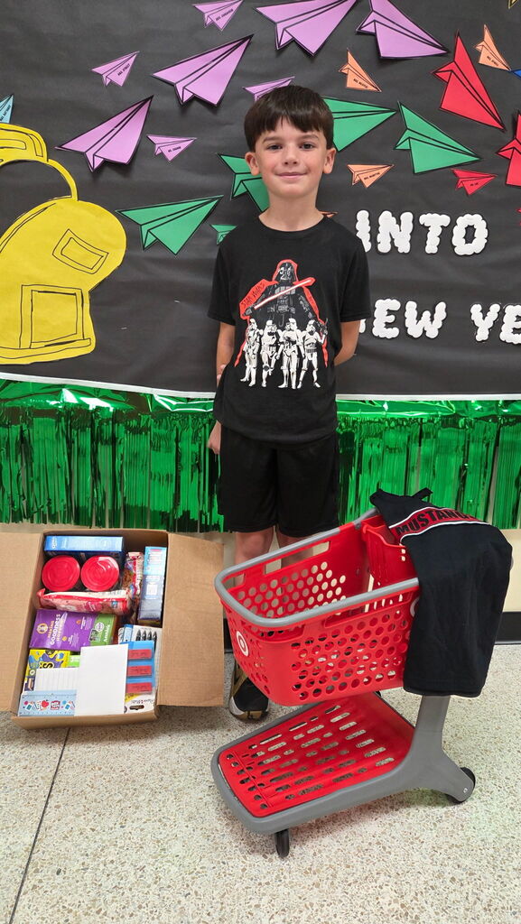 Fifth grader Joseph Fox, winner of the Mathews Elementary School Box Tops raffle, poses with his prize.