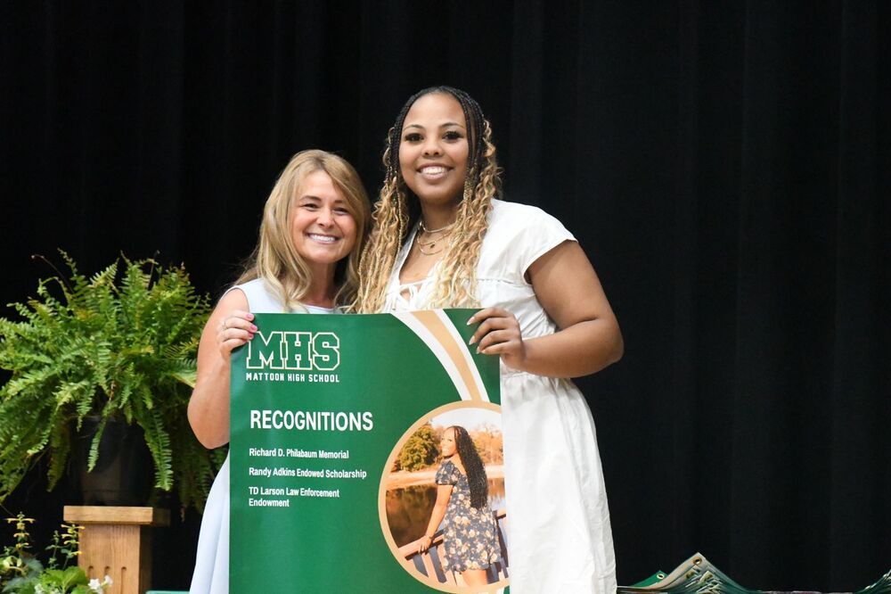 Scholars Day - Student holding a banner of awards with Guidance Counselor