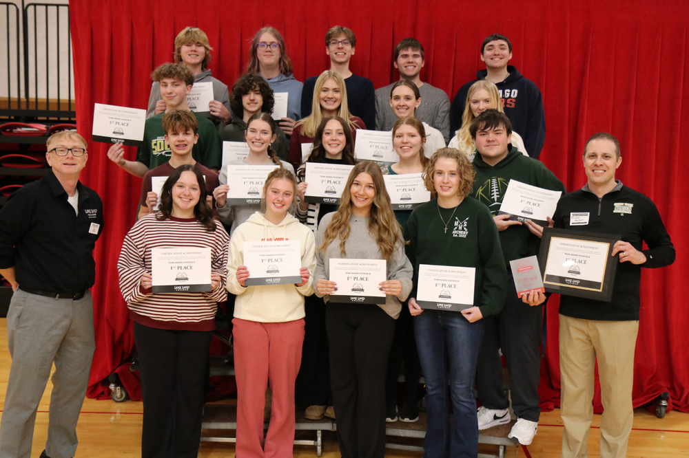 Group photo of the Mattoon High School Academic Challenge team that placed first out of eight teams in Division B at the Lake Land Academic Invitational. They are holding cerrtificates