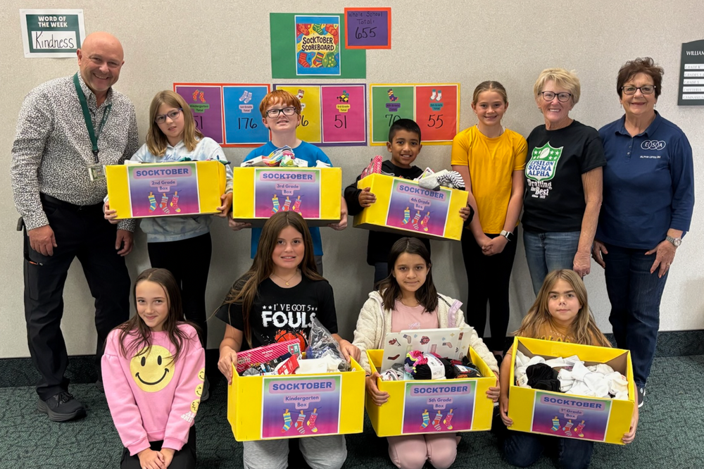 Williams Elementary Students, staff, and volunteers who participated in Socktober drive. The kids are holding boxes of donations