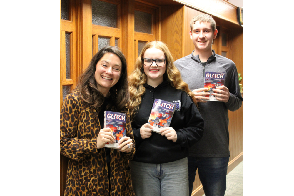 Two MMS students and the librarian holding the new Read Across Mattoon book "Glitch"