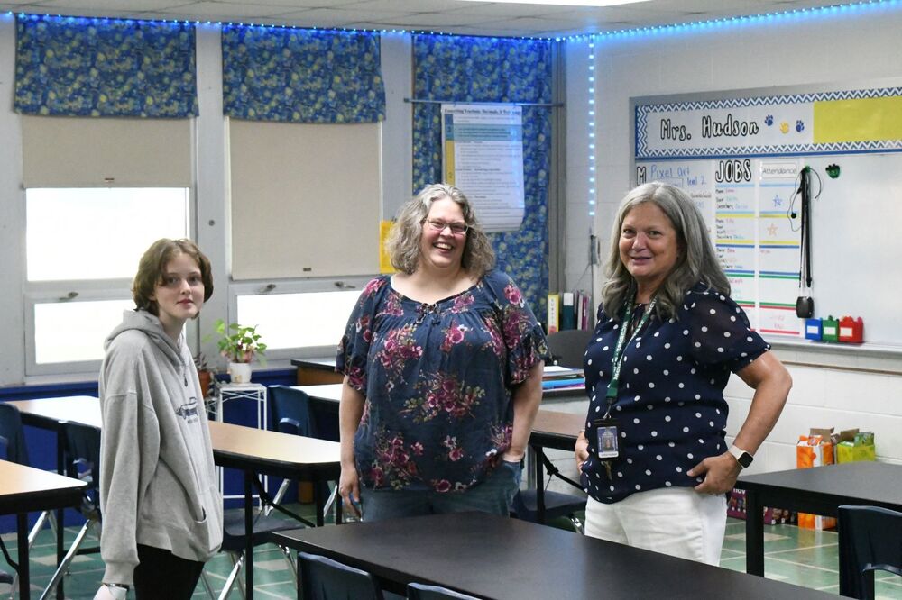 MMS family talking to a staff member in a classroom at their open house