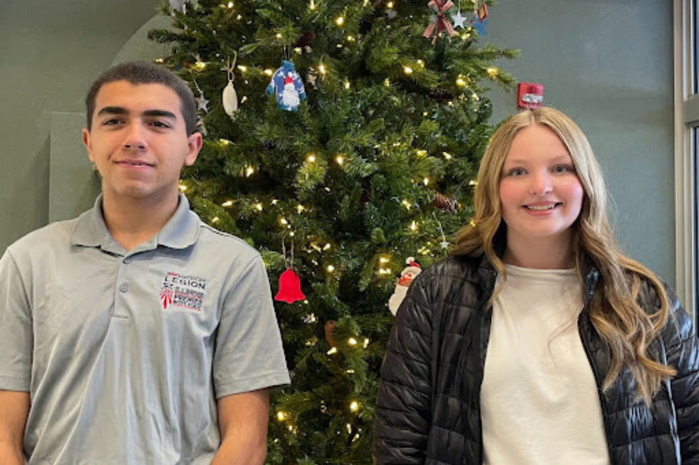 Mattoon Rotary Students of the Month for December pictured next to a Christmas Tree