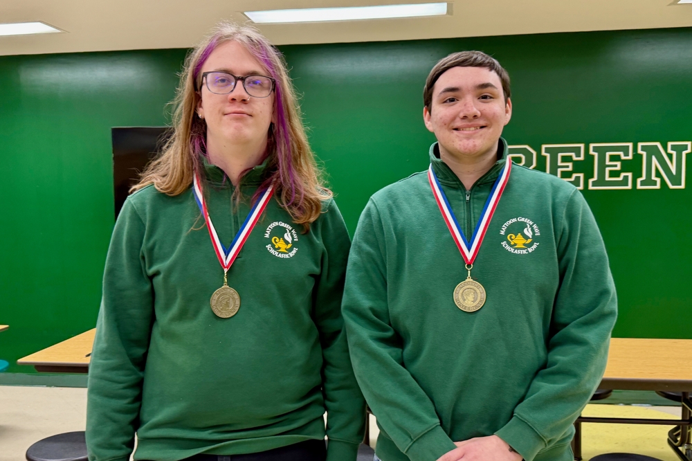 Two MHS students who earned All-Conference honors at the Apollo Conference Scholastic Bowl Tournament. They are wearing medals and standing in the cafeteria
