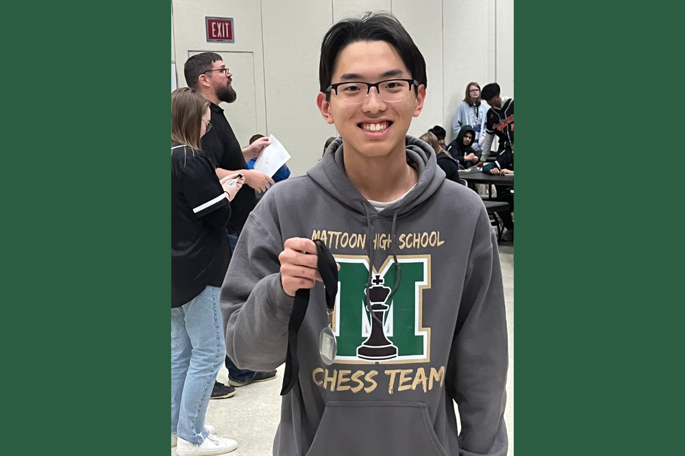 MHS Student holding a medal at the chess tournament
