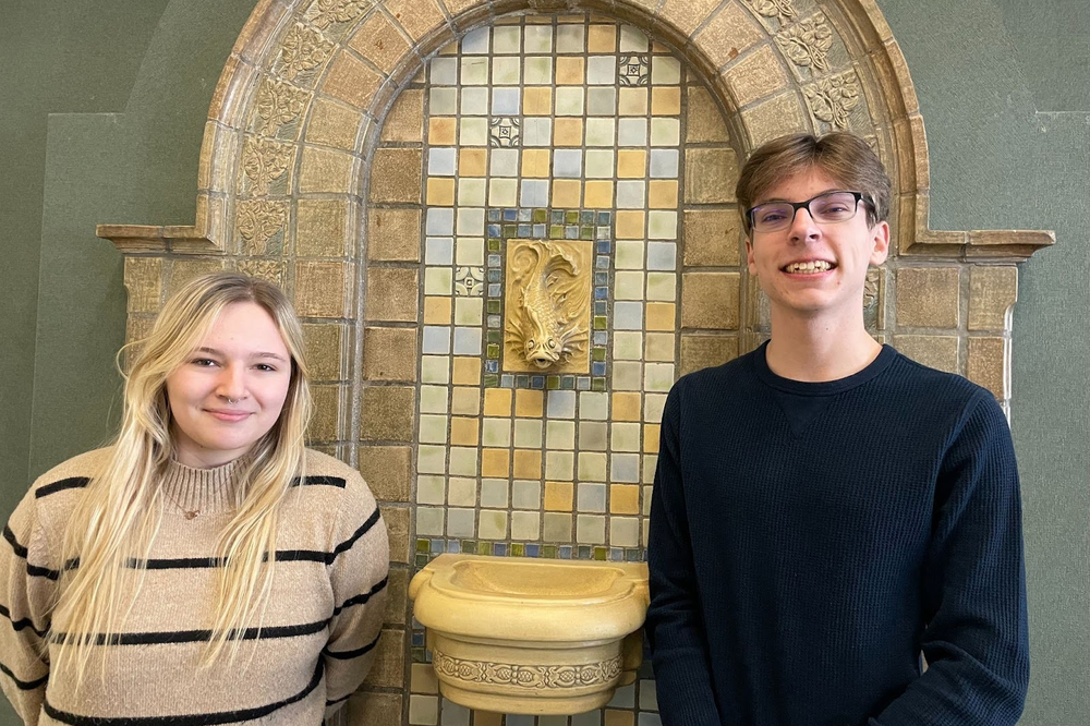 TWO MHS students standing by a fountain. They are the January Rotary Students of the Month