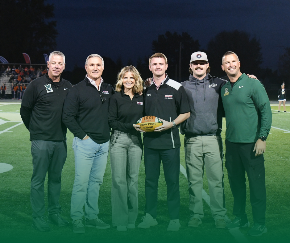 Photo of the Pilson Stadium Naming Celebration. Pictured are the Superintendent and Athletic director with the Pilson family