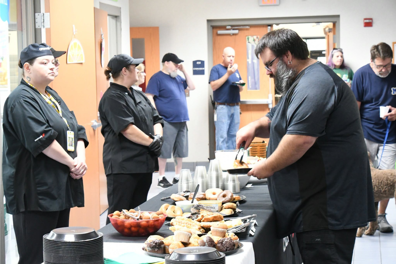 staff member going through the breakfast line at the back to school breakfast