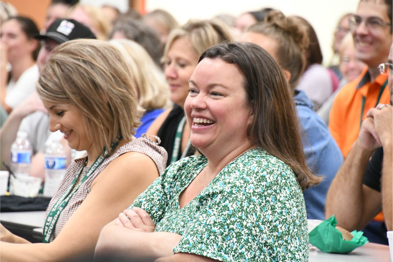 staff member laughing at the back to school breakfast