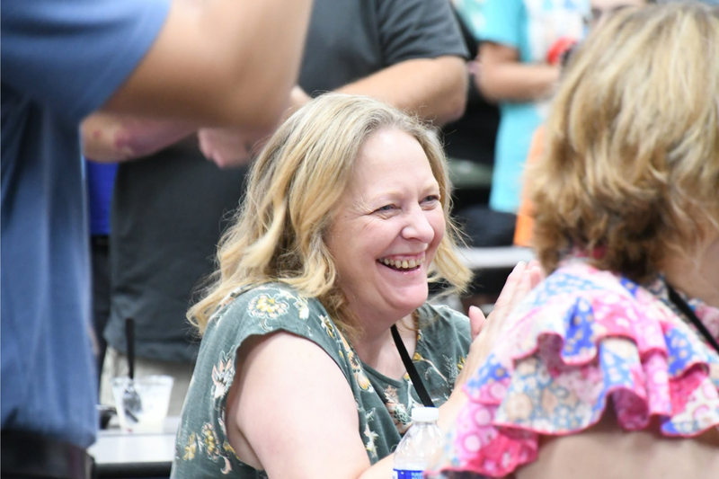 staff member laughing at the back to school breakfast