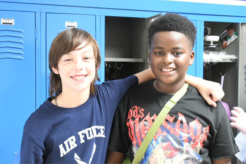two students posing in front of lockers at MMS