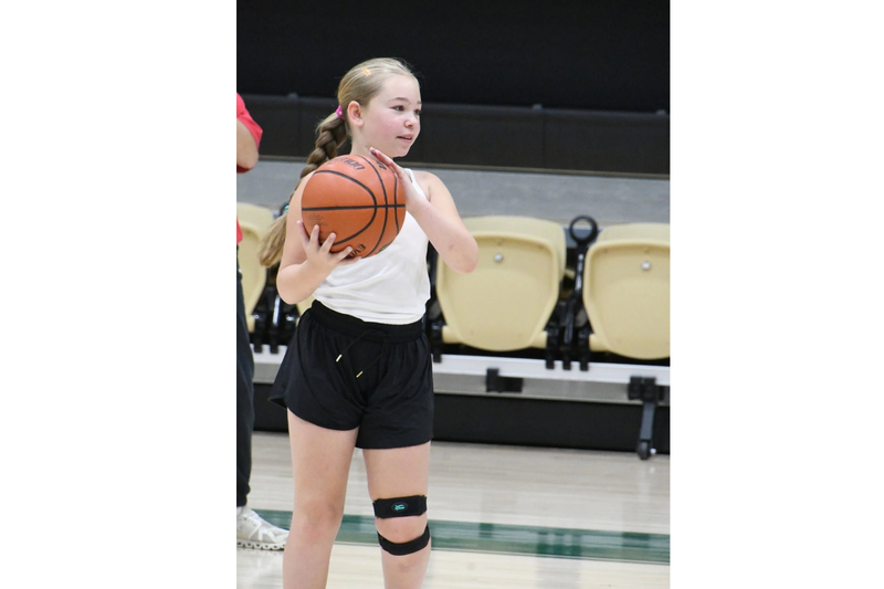 MHS youth basketball camp. Student holding a basketball