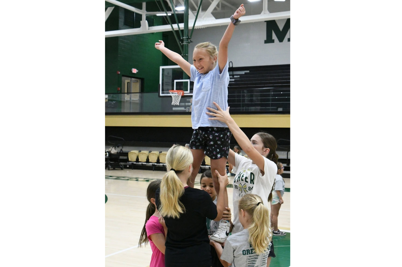 MHS youth summer camp. Students doing a cheer. 