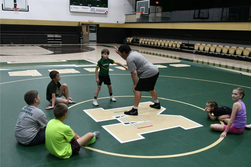 MHS youth summer camp. Wrestling on mats