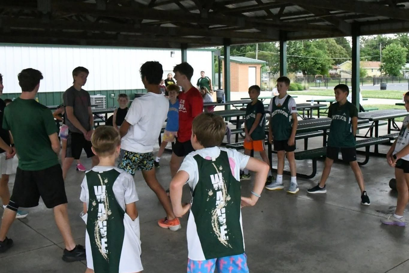 MHS youth summer camp. Cross country students stretching outside