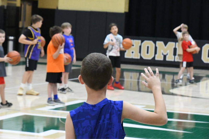 MHS youth summer camp. Students playing basketball on the court