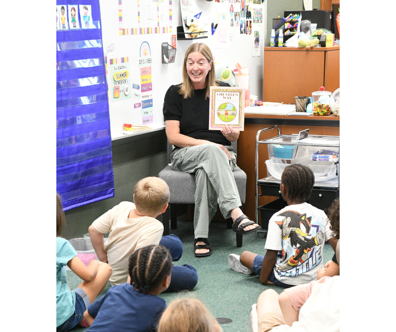 WAND Educator of the Month winner Brenda Bell reading a book to her first grade students at williams elementary school