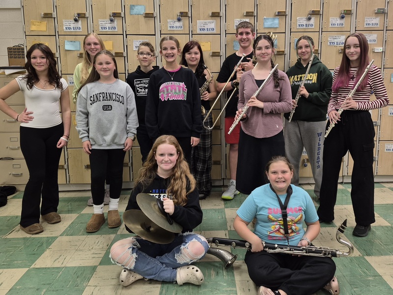 12 students pictured chosen to perform at the ILMEA honor band and choir performance from MMS. Band students are holding instruments