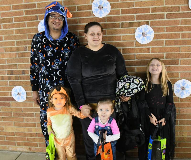 Family of five dressed up in costumes for the Franklin Trick or Treat event