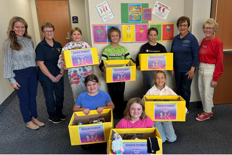 Riddle Elementary Students, staff, and volunteers who participated in Socktober drive. The kids are holding boxes of donations
