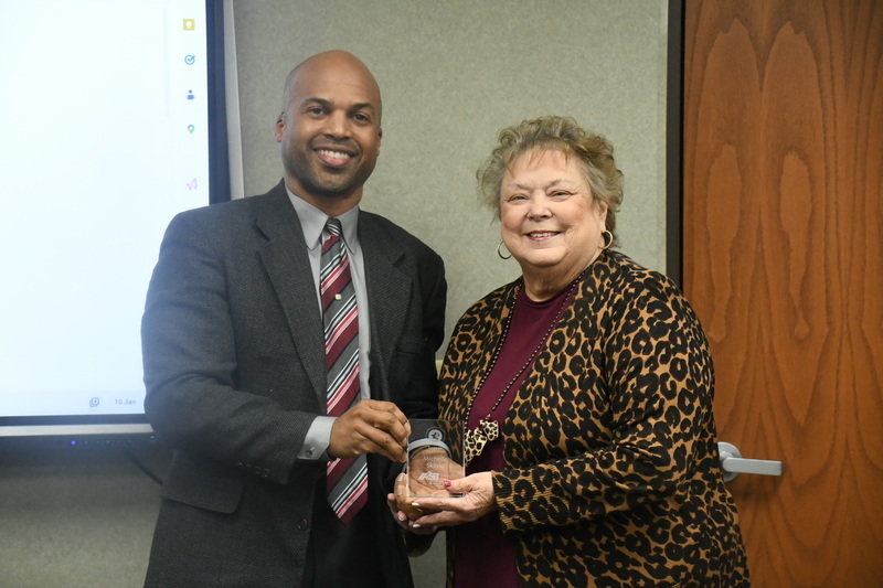 Dr. Perry Hill awarding President, Michelle Skinlo