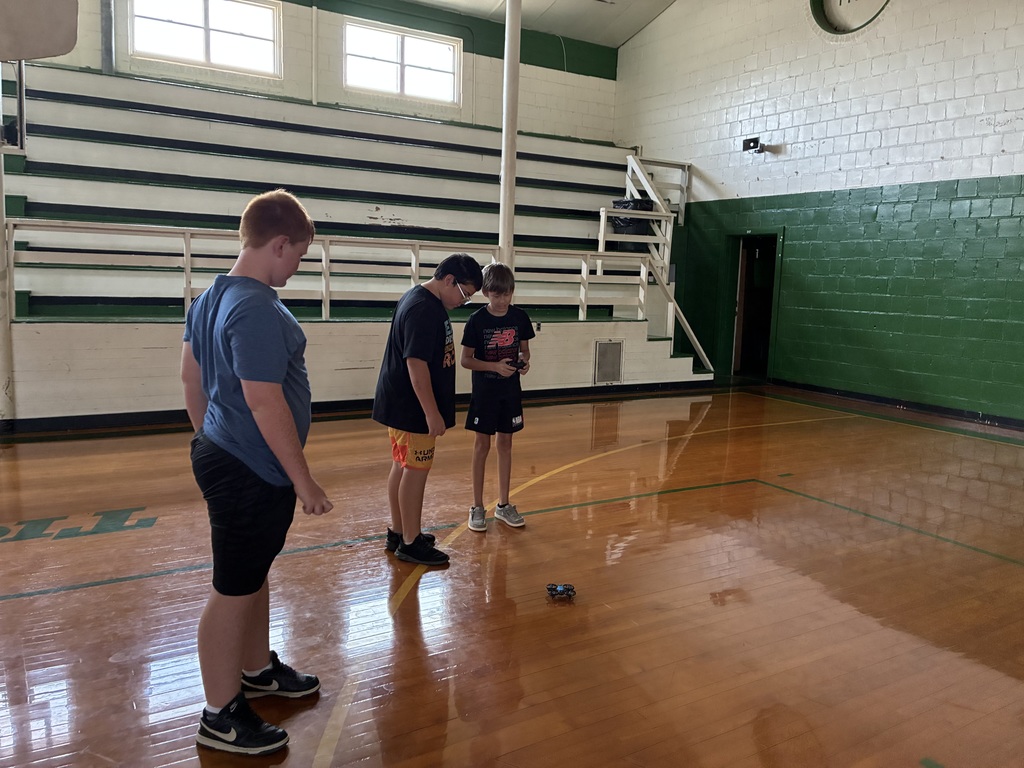 Sixth Grade STEM Class learning how to operate drones.